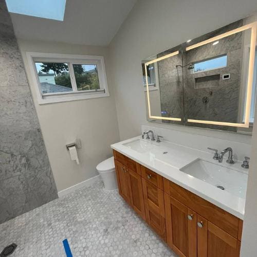 A bathroom mid-remodel: hex tile floor laid, vanity set, finish work still open