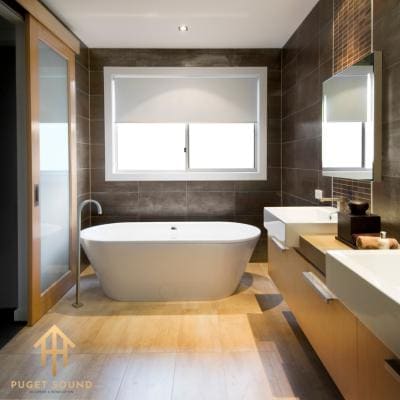 Finished bathroom with freestanding tub and dark tile feature wall